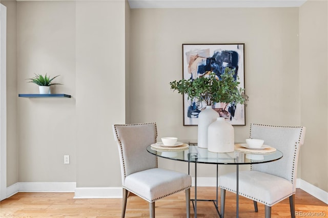 dining room featuring wood finished floors and baseboards