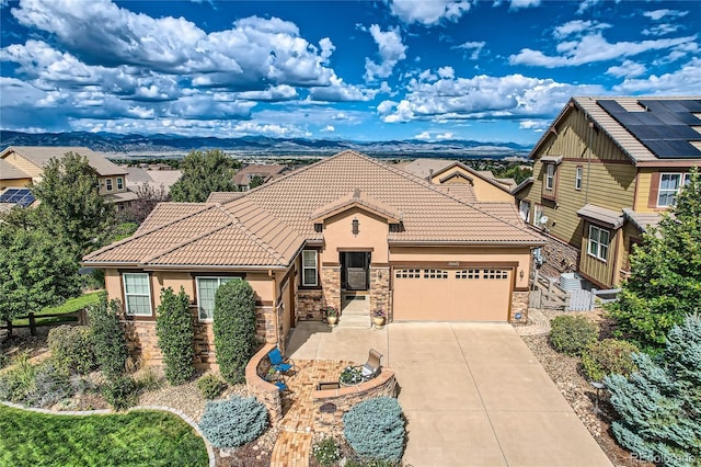 view of front of property featuring a garage and a mountain view