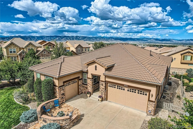 view of front of property featuring a mountain view and a garage