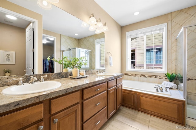 bathroom featuring vanity, independent shower and bath, and tile patterned flooring