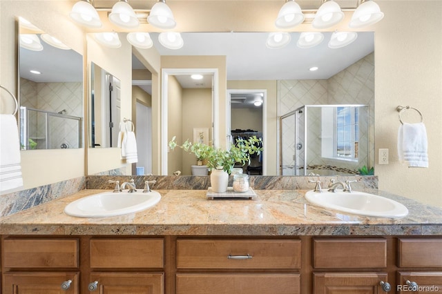 bathroom featuring vanity and a shower with door