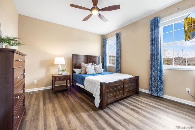 bedroom with ceiling fan and dark hardwood / wood-style floors