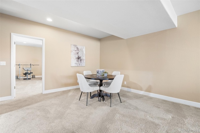 dining area featuring light carpet