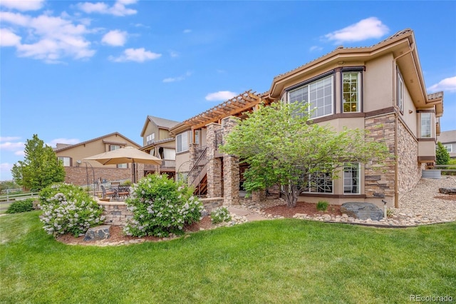 back of property featuring a lawn and a patio area