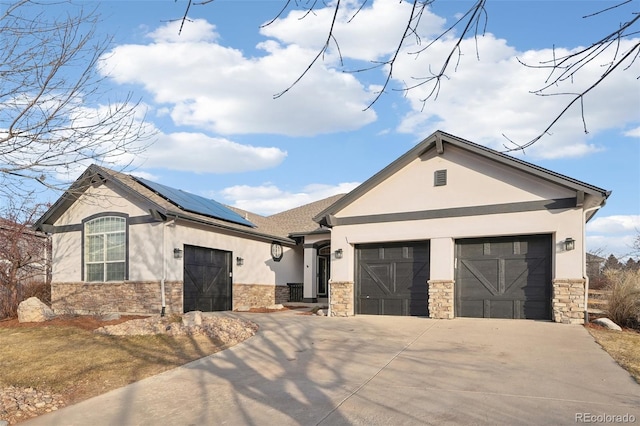 view of front of house with a garage and solar panels