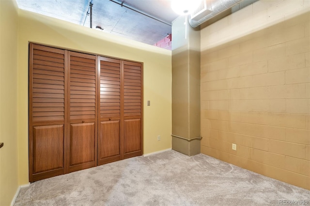 unfurnished bedroom featuring a closet and light carpet