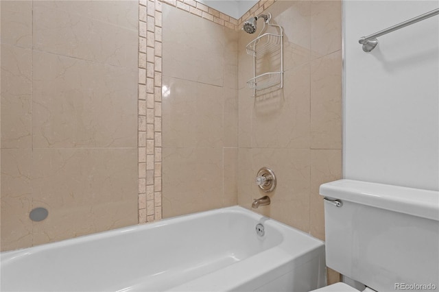 bathroom with tiled shower / bath and toilet