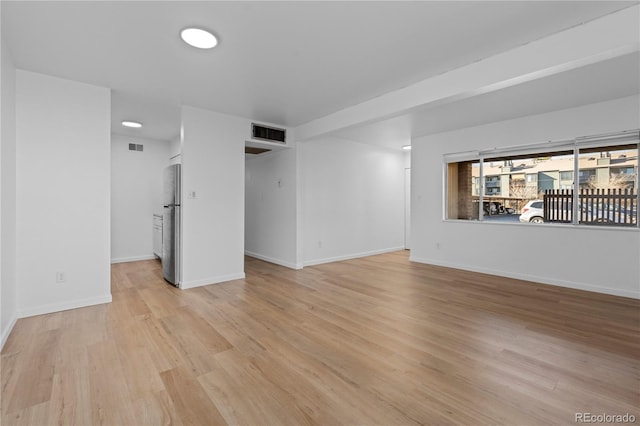 unfurnished living room featuring light wood-type flooring