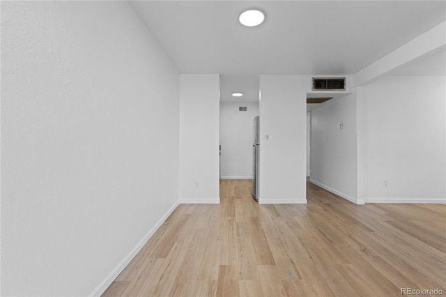 empty room with light hardwood / wood-style flooring