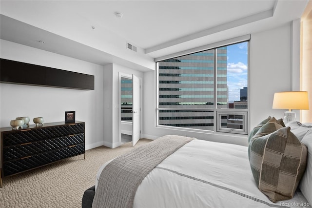 bedroom featuring a view of city, carpet, visible vents, and baseboards