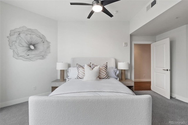 carpeted bedroom with baseboards, visible vents, and ceiling fan