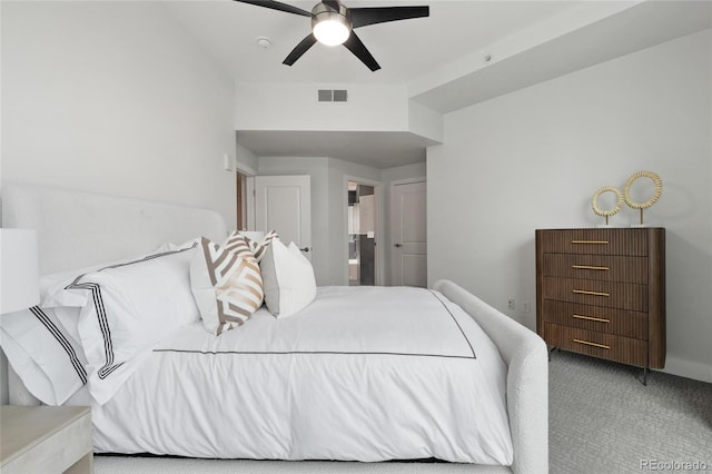 carpeted bedroom featuring a ceiling fan, visible vents, and connected bathroom