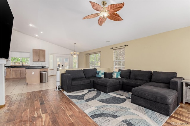 16257 E 105th Cir, Commerce City, CO 80022 - living room featuring light wood-type flooring, a ceiling fan, french doors, a chandelier, and recessed lighting