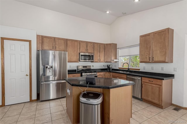 16257 E 105th Cir, Commerce City, CO 80022 - kitchen featuring appliances with stainless steel finishes, high vaulted ceiling, light tile patterned flooring, a sink, and a center island