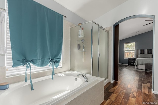 16257 E 105th Cir, Commerce City, CO 80022 - full bath with a stall shower, ensuite bath, a bath, lofted ceiling, and wood finished floors