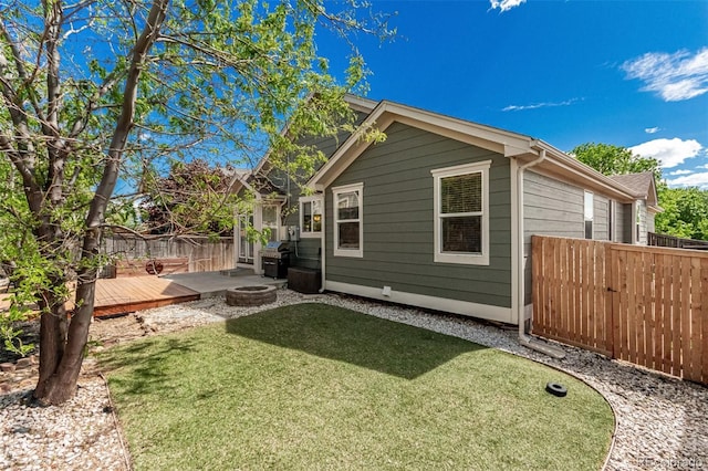 16257 E 105th Cir, Commerce City, CO 80022 - back of property featuring a deck, an outdoor fire pit, and a putting green
