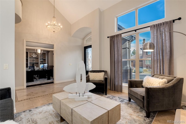 tiled living room with high vaulted ceiling and a notable chandelier