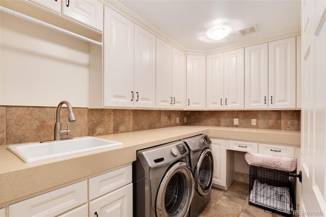 washroom with sink, light tile patterned floors, cabinets, and independent washer and dryer