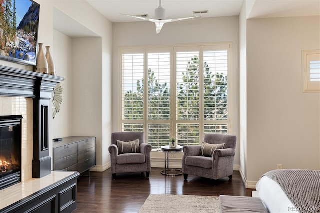 sitting room featuring dark hardwood / wood-style floors, a healthy amount of sunlight, and a fireplace