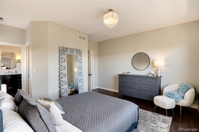 bedroom featuring an inviting chandelier and dark wood-type flooring