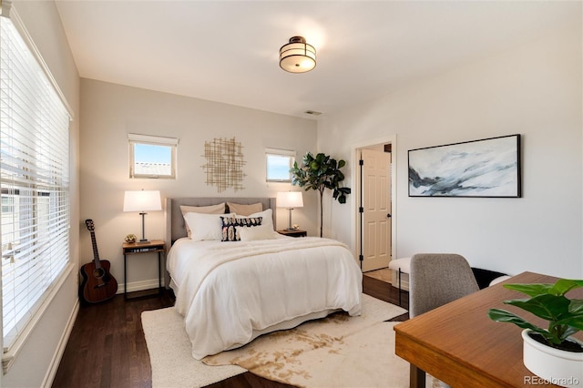 bedroom with dark wood-type flooring