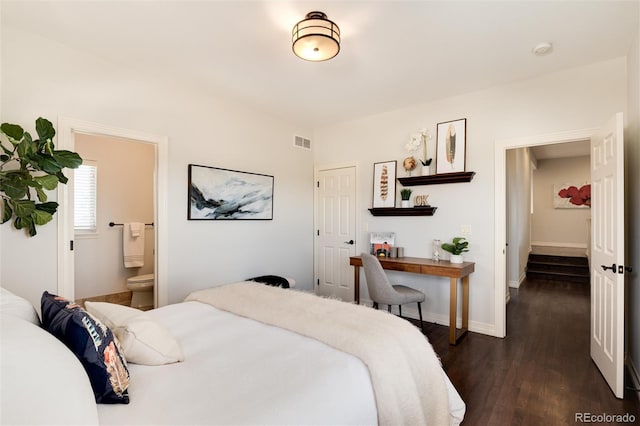 bedroom featuring dark hardwood / wood-style flooring and ensuite bathroom