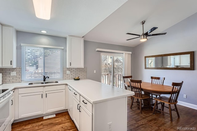 kitchen featuring sink, white cabinetry, tasteful backsplash, and kitchen peninsula