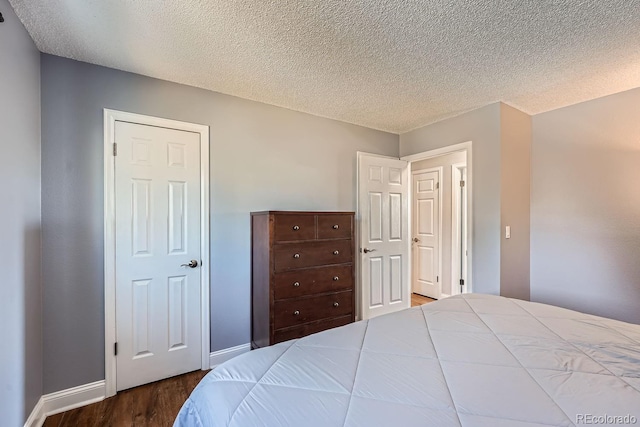 bedroom with hardwood / wood-style flooring and a textured ceiling