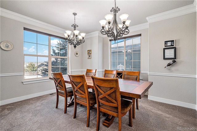 dining room with ornamental molding, a chandelier, and carpet flooring