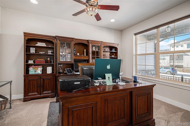 carpeted office featuring ceiling fan