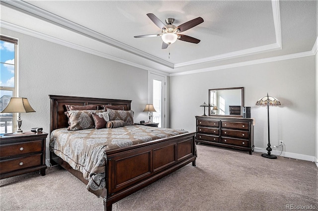 bedroom with ceiling fan, light colored carpet, multiple windows, and a raised ceiling