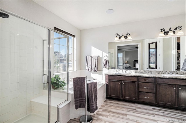 bathroom featuring walk in shower and vanity