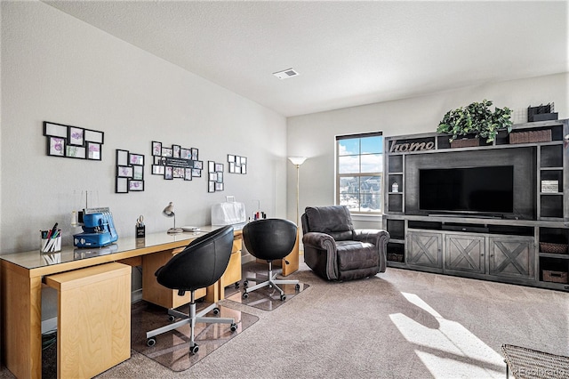 office space with a textured ceiling and carpet