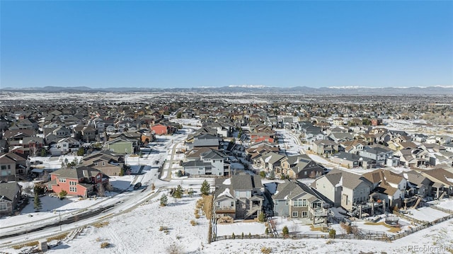 snowy aerial view with a mountain view