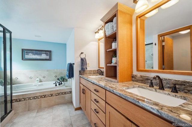 full bathroom featuring a stall shower, tile patterned flooring, a sink, and a bath