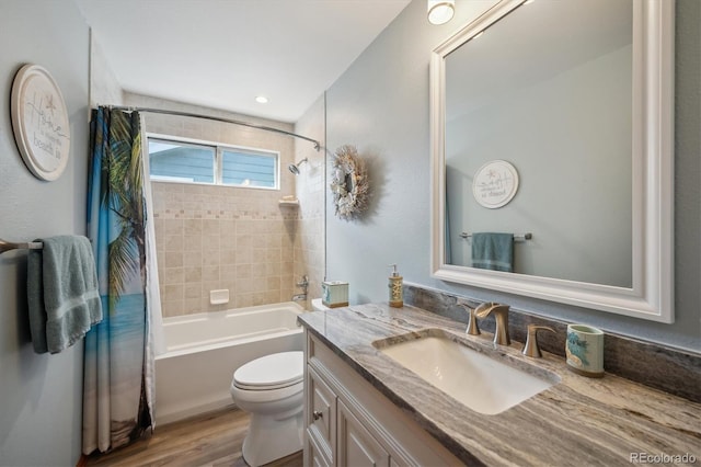 full bath featuring wood finished floors, vanity, toilet, and shower / tub combo with curtain