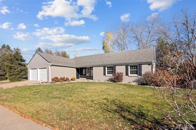 single story home featuring a front yard, an attached garage, brick siding, and concrete driveway