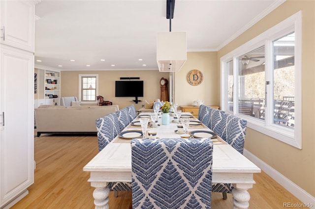 dining room featuring crown molding, baseboards, light wood-type flooring, recessed lighting, and a ceiling fan