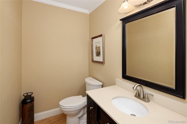 half bath with crown molding, baseboards, toilet, wood finished floors, and vanity