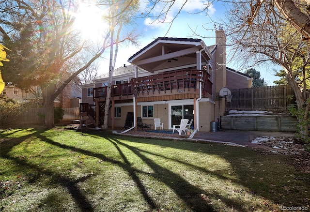 rear view of house with a deck, a patio, a fenced backyard, and a chimney