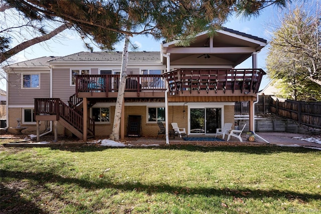 back of house featuring a patio area, a lawn, stairs, and fence