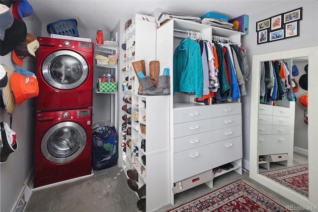 washroom with laundry area, stacked washing maching and dryer, baseboards, and carpet floors