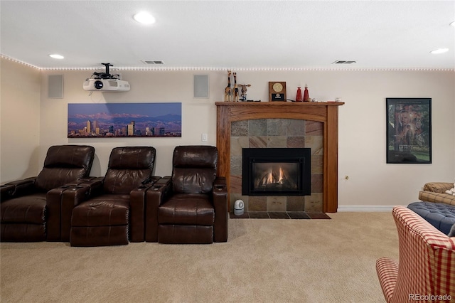 carpeted home theater with recessed lighting, a fireplace, visible vents, and baseboards