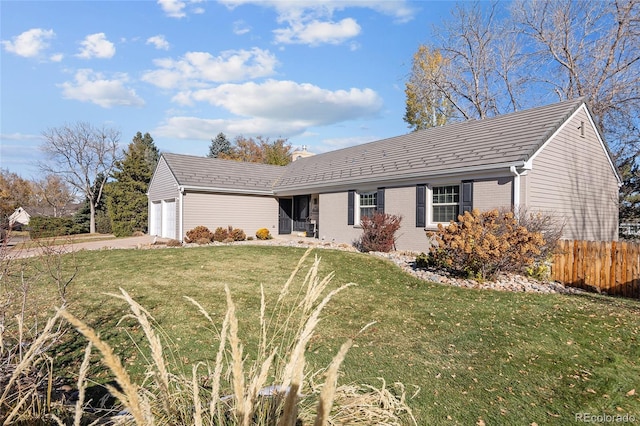 ranch-style house with a front lawn, brick siding, an attached garage, and fence