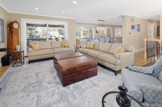 living area with recessed lighting, visible vents, baseboards, and crown molding