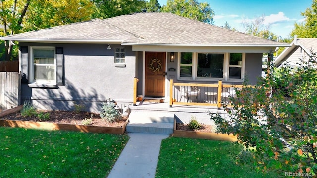 bungalow-style house with a porch and a front lawn