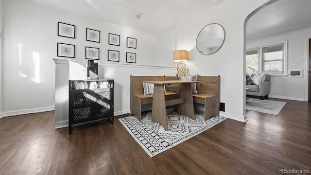 dining space with dark wood-type flooring