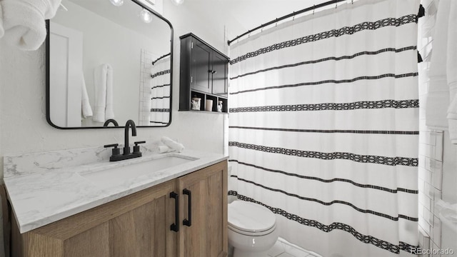 bathroom featuring toilet and vanity