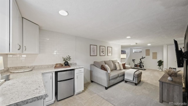 tiled living room featuring a textured ceiling