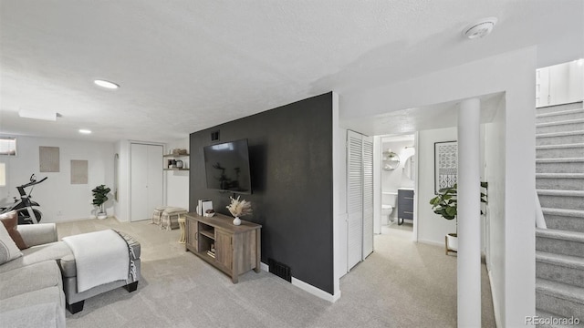 living room featuring a textured ceiling and light carpet